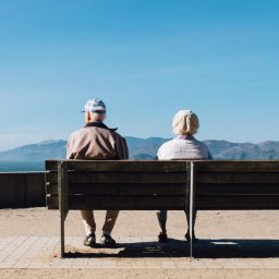 older couple sitting on a bench