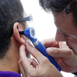 doctor looking into an ear