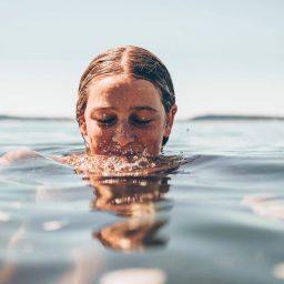A woman with her head halfway in water
