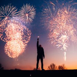 Man standing with fireworks in the sky