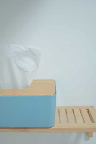 A box of tissues on a shelf.