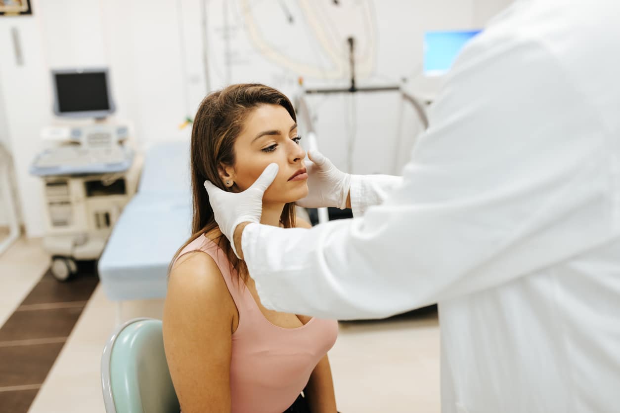 Woman having her nose examined by a doctor
