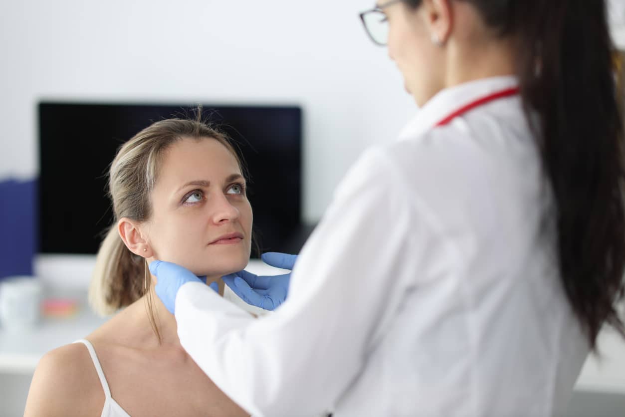 Doctor examining a woman's glands