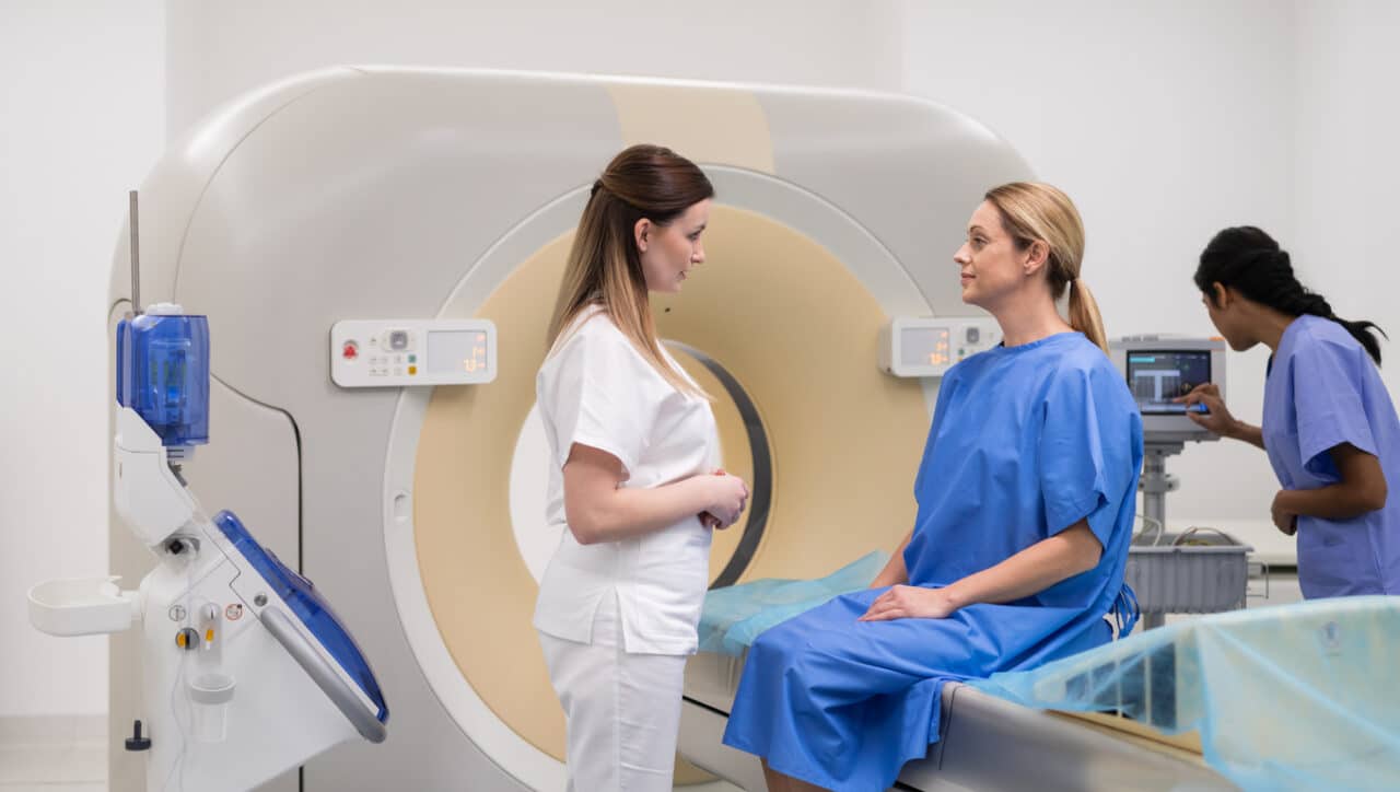 Doctor explaining the process of a CT scan to her patient.