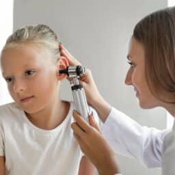 Young girl gets ears examined