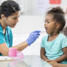 ENT provider examining a young girl's throat