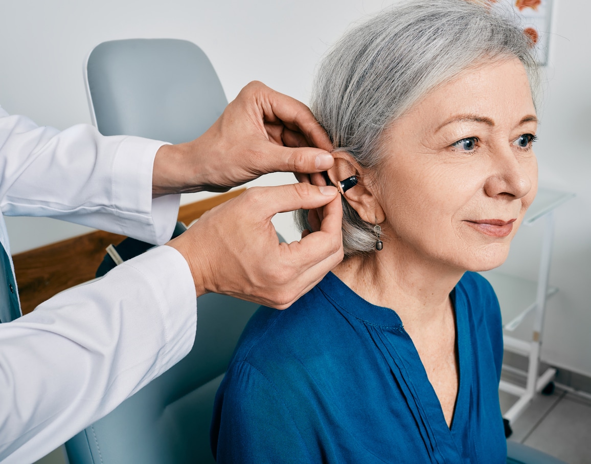 Senior woman getting her first hearing aid.