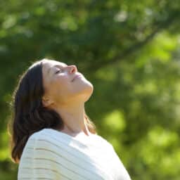 Woman breathing fresh air in the park